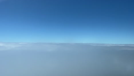 a pilot’s perspective recorded from a jet cockpit flying just some layers of clouds during the descend to funchal airpor, madeira