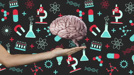 cerebro girando sobre una mano contra los iconos del concepto de la ciencia en fondo negro