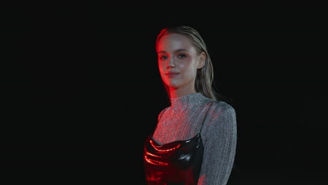 sexy girl enjoying nightlife in red neon light closeup. seductive lady walking