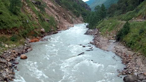 beautiful scenic white glacial river flows wild through the bhote koshi gorge in the remote mountains in nepal