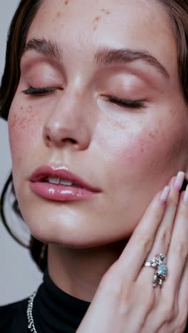 close-up fashion portrait of a woman with freckles
