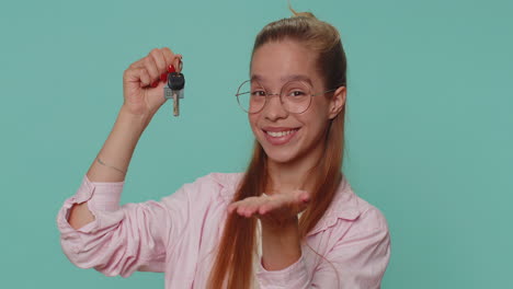 teenager girl real estate agent showing keys of new home house apartment, buying renting property