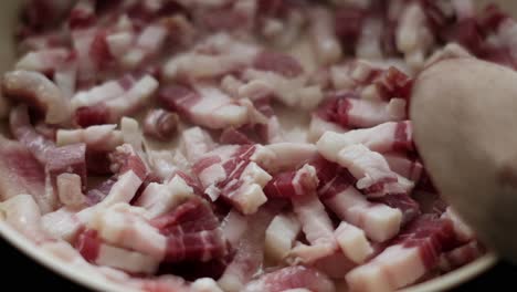 slow-motion shot of pancetta or guanciale strips sizzling for carbonara. sizzling food 4k