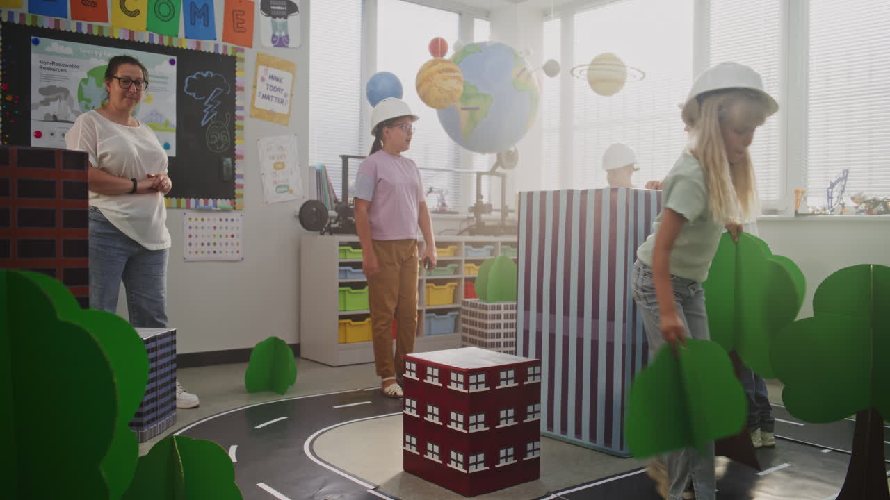 Team of Primary School Students in Hardhats Creating City Planning