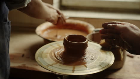 Man-and-woman-sculpting-in-pottery.-Girl-preparing-to-modeling-in-workshop