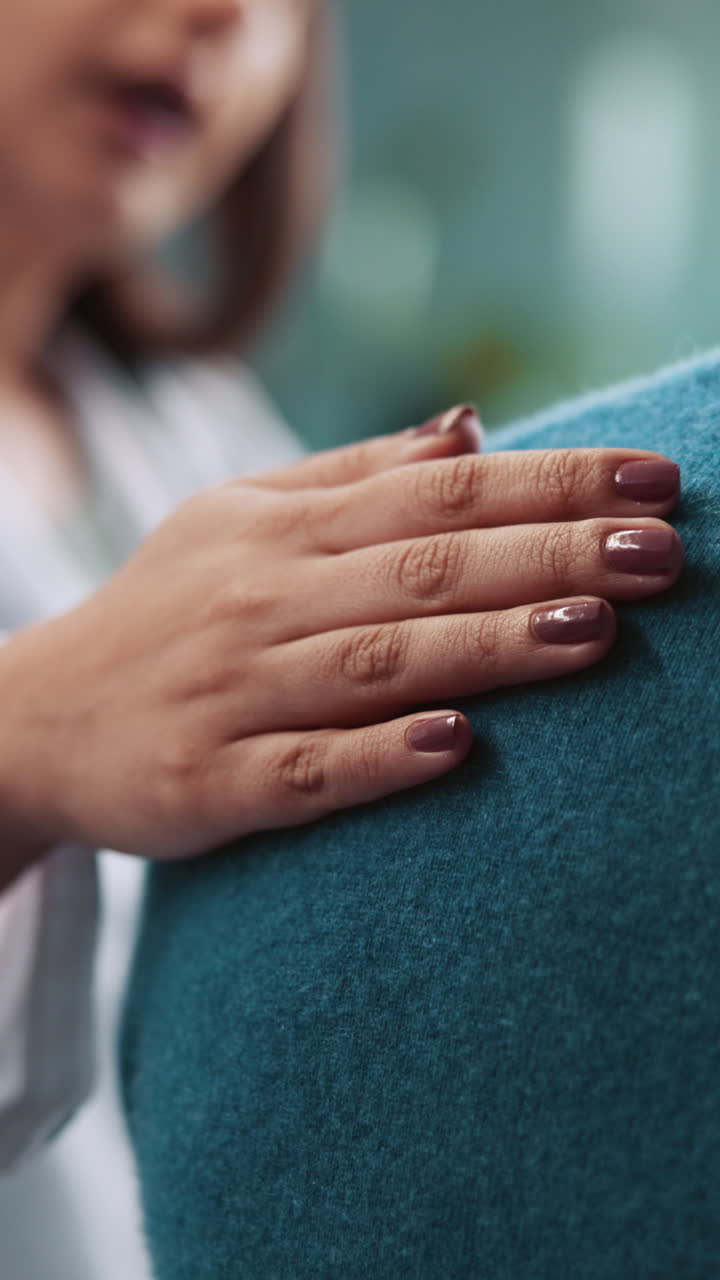 Close Up of Hand Gently Patting a Shoulder