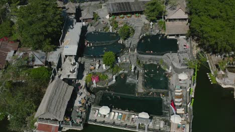 aerial top down of tourists enjoying hot springs near mount batur volcano in bali indonesia