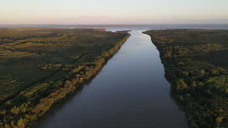 aerial high shot of long amazon river at sunset with large rainforest at the sides 4k