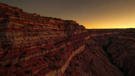 vast canyon landscape with layered rock formations at sunset
