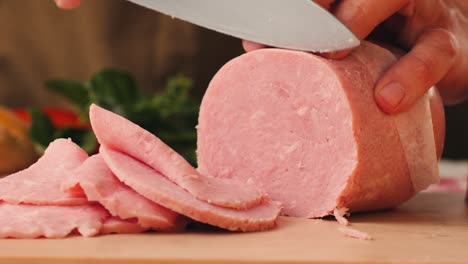 ham italian mordatella, man slices of traditional italian antipasti mortadella sausage on a wooden cutting board, close up macro of chicken or turkey jamon, fat breakfast dish.