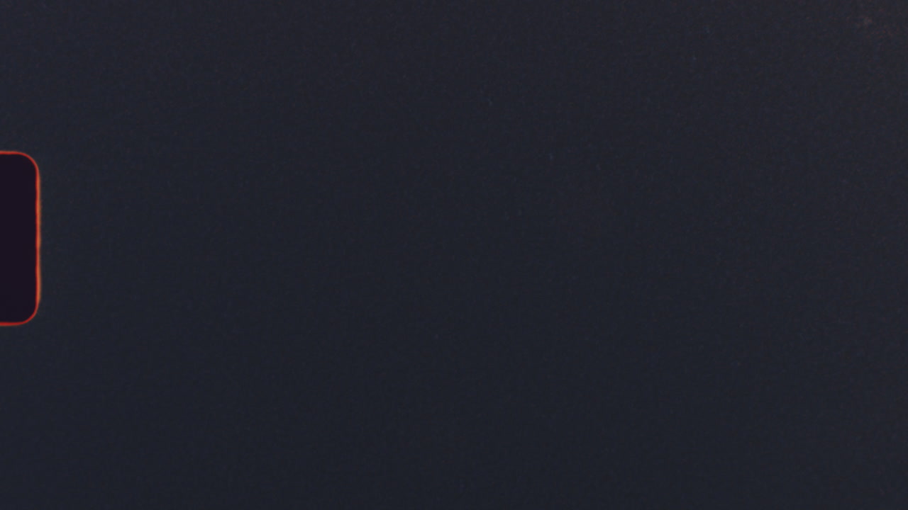 Black frame with red film burn detail on super 8mm footage