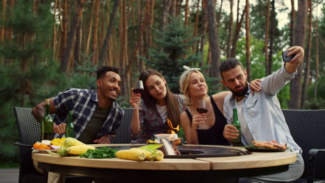 smiling friends making selfie outdoors. happy people doing photo on smartphone