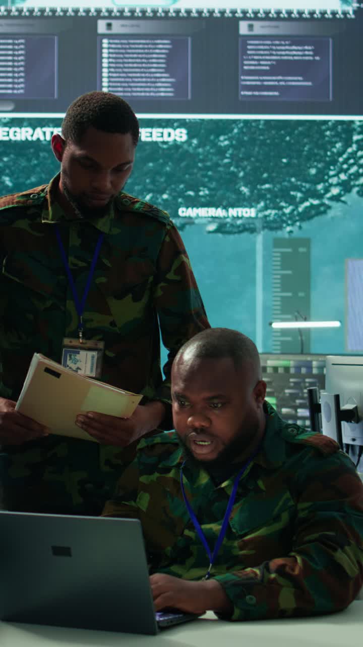 Vertical Video Military personnel in a modern command center handle critical information