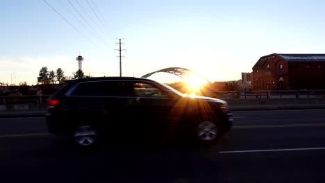 slow motion footage of cars passing through a bridge in denver downtown