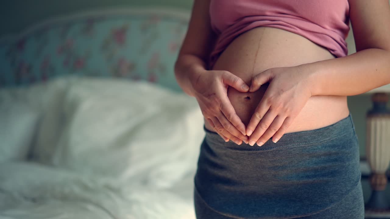 Happy pregnant woman and expecting baby at home.
