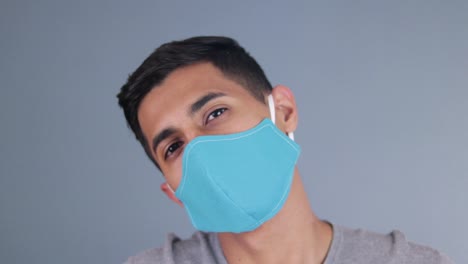 handsome hispanic model wearing a face mask at the covid pandemic