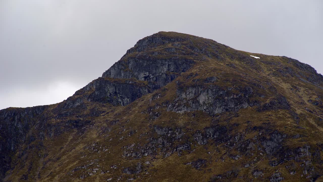 Static shot of a munro mountain on a cloudy day in the glens and hills around Glasgow
