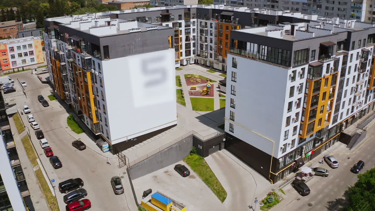 Block of flats in urban area. Aerial view of multi storey residential buildings