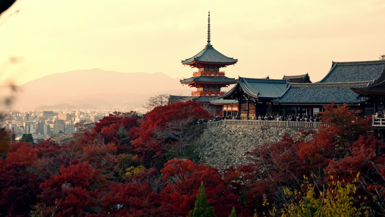 Immerse yourself in the beauty of Kyoto’s Kiyomizu-dera Pagoda surrounded by vibrant red foliage during the autumn sunset.