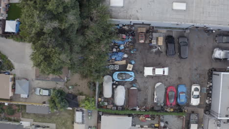 4K-overhead-tracking-shot-of-auto-body-shop-and-car-wash