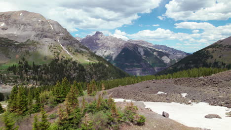 low drone push in colorado mountains over pine trees