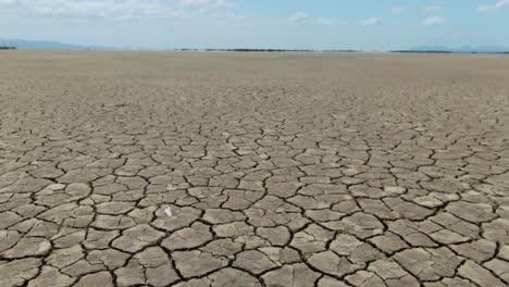 drone flyover forward over cracked soil of casuarina island due to climate change and drought