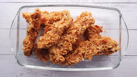 fried chicken fillets on plate on blue background