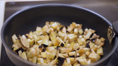 fresh eggplant cut in chunks cooking in a pan