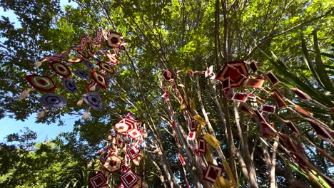 vibrant mobiles sway among lush green trees