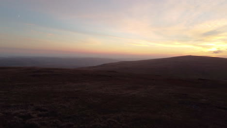 A-4K-Aerial-Drone-Shot-Rising-Over-Brecon-Beacons-During-Sunset-with-a-Crescent-Moon