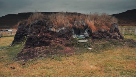 a creepy turf hut in the desolate tundra landscape