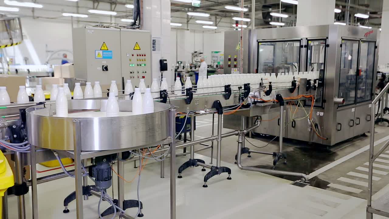 Beverage industry manufacturing line. Milk bottles on conveyor belt