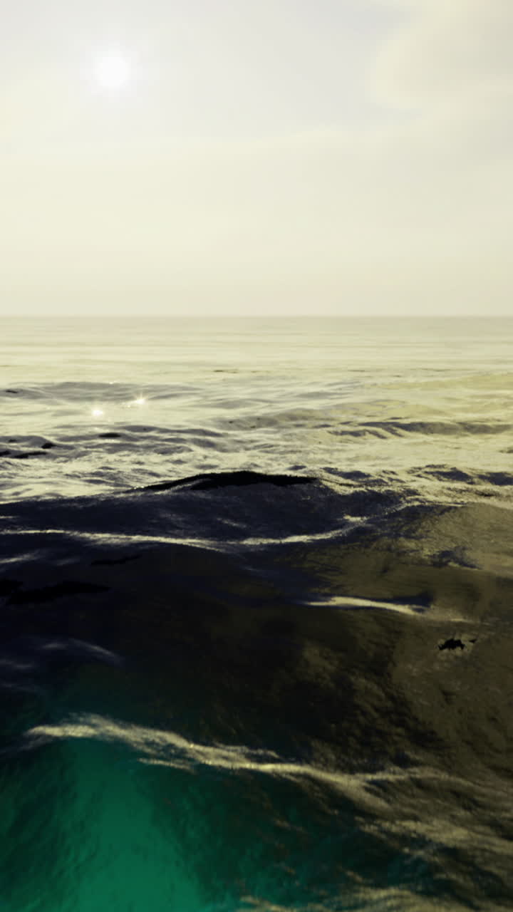 Calm ocean waves reflect the soft light of a serene evening sky