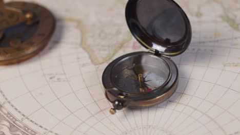 Close-up-od-an-antique-compass-on-a-vintage-map