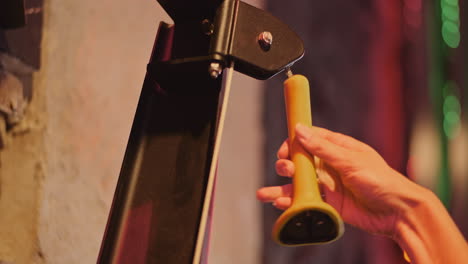 cropped hand of young woman exercising on cable machine at fitness club