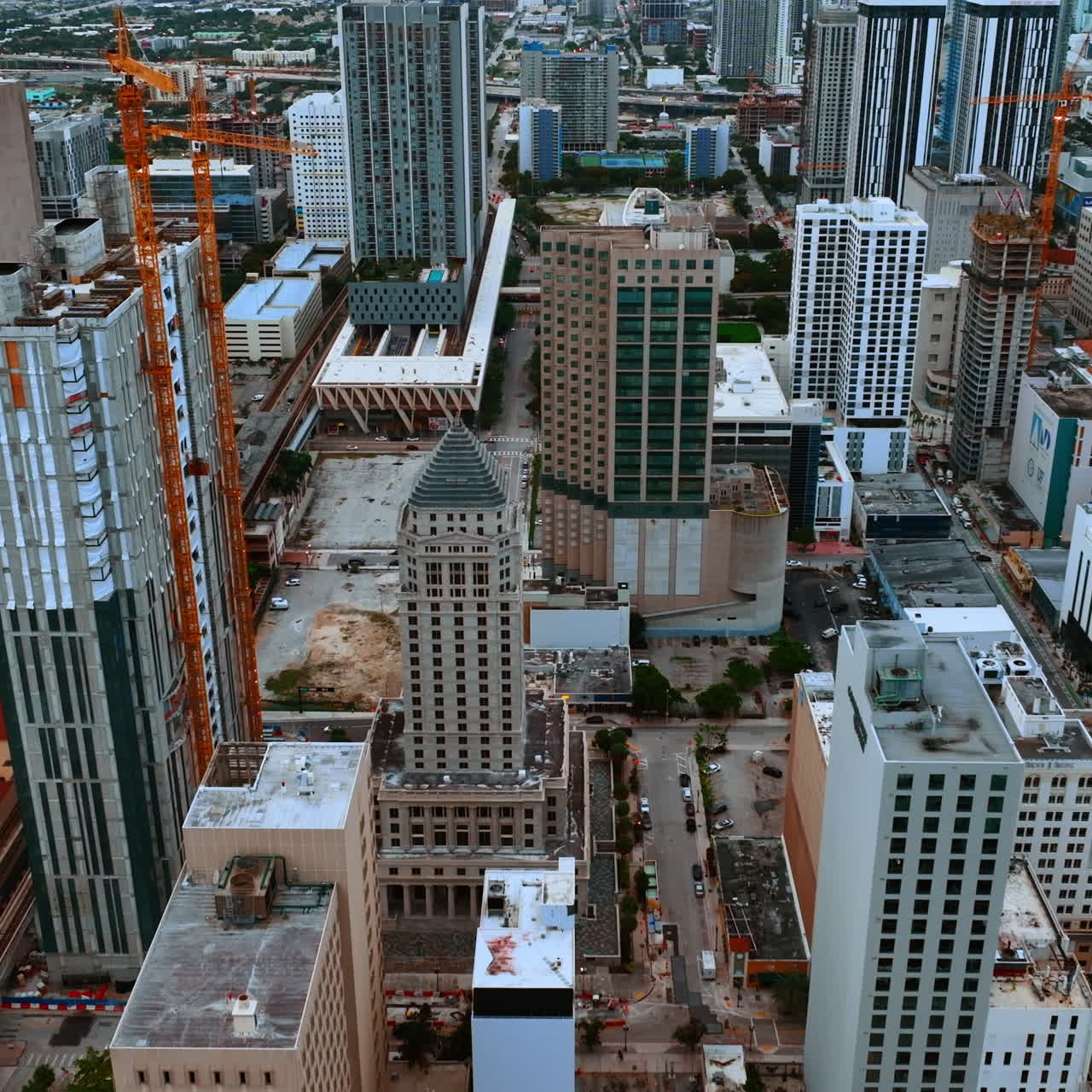 Flight above the diverse beautiful buildings in Miami cityscape. Drone footage of metropolis at daytime.