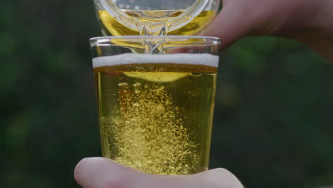 slow motion transferring beer from a jar to a glass