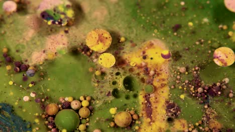 abstract colorful acrylic and food paint bubbles on water