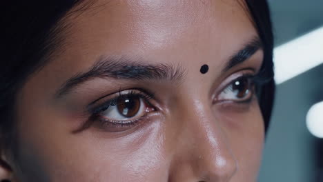 close-up of a woman's eyes and forehead with a bindi