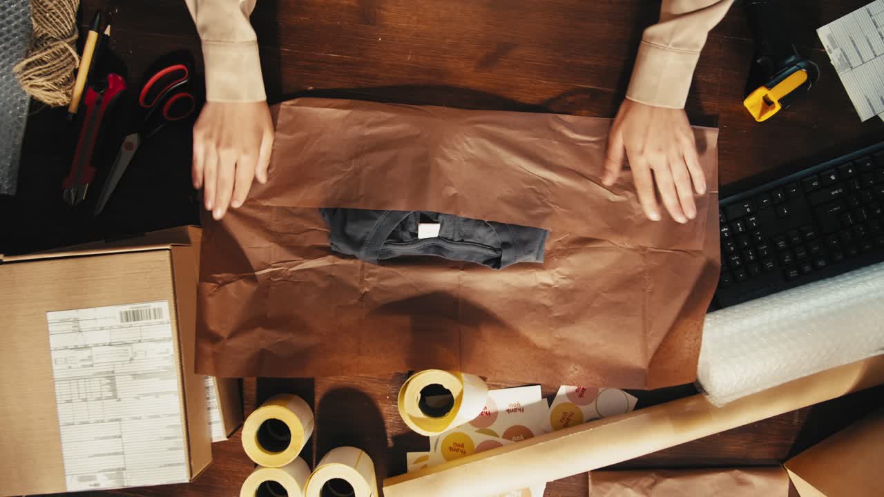 Woman Packing a T-Shirt for Delivery