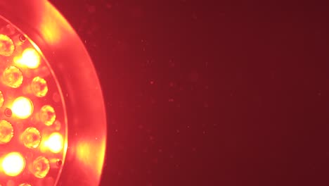 red industrial entertainment light revealing small dust particles floating through the sky.