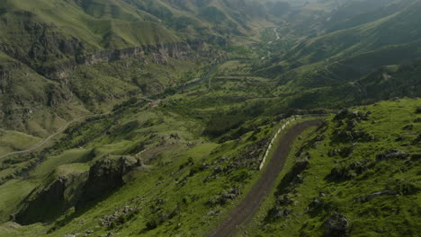 Panorama-Of-Green-Mountain-Range-With-Dirt-Road-In-The-Early-Morning-In-Georgia