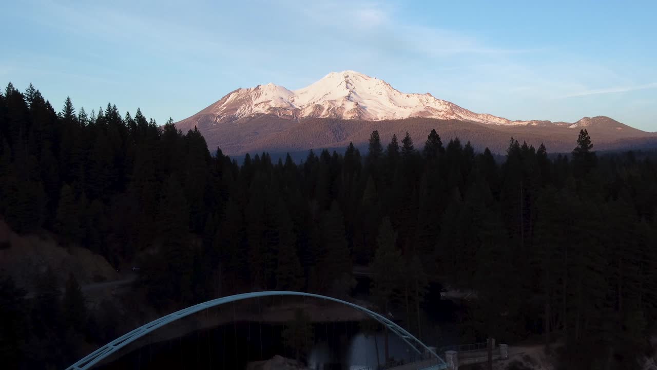 Aerial: Walking Bridge at Siskiyou Lake with view of Mt. Shasta. 4K