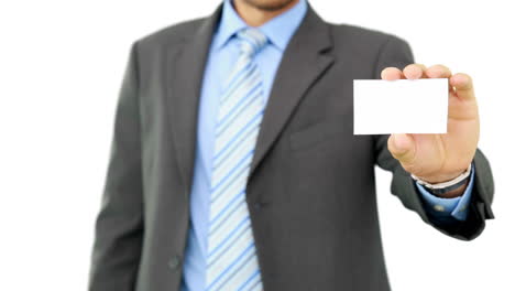 Young-businessman-showing-card-to-camera