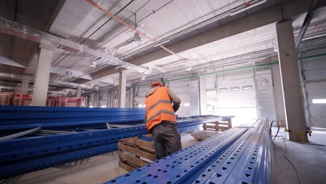 big and modern warehouse under construction, featuring metal shelving and other industrial equipment.