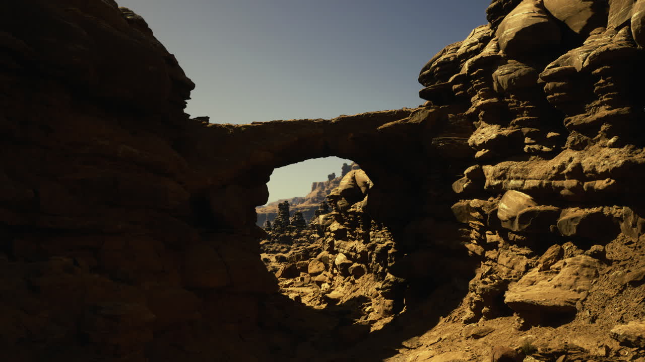 Rock formation arches over dry landscape capturing the essence of nature