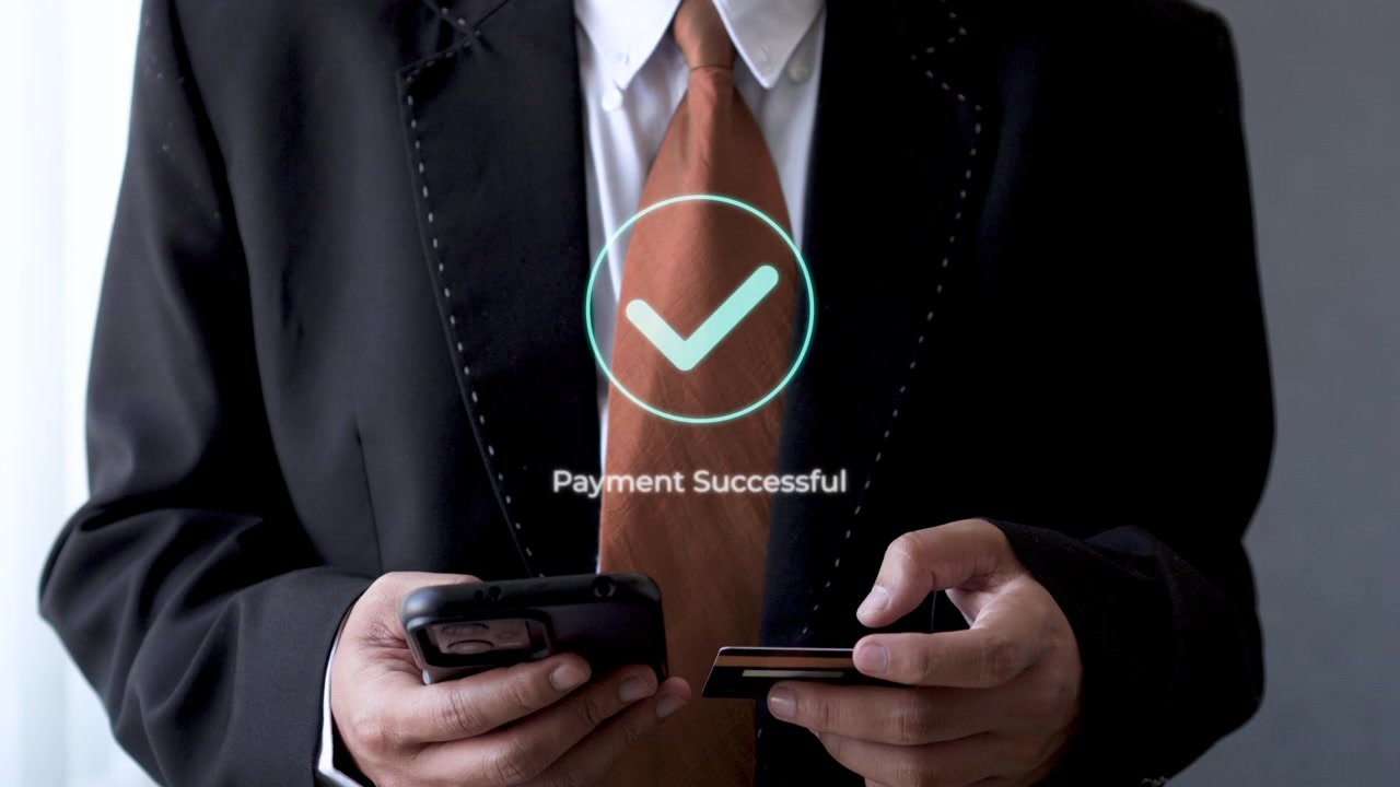 Businessman using smart phone and credit card for touchless payment with successful confirmation