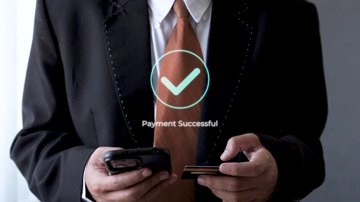 Businessman using smart phone and credit card for touchless payment with successful confirmation