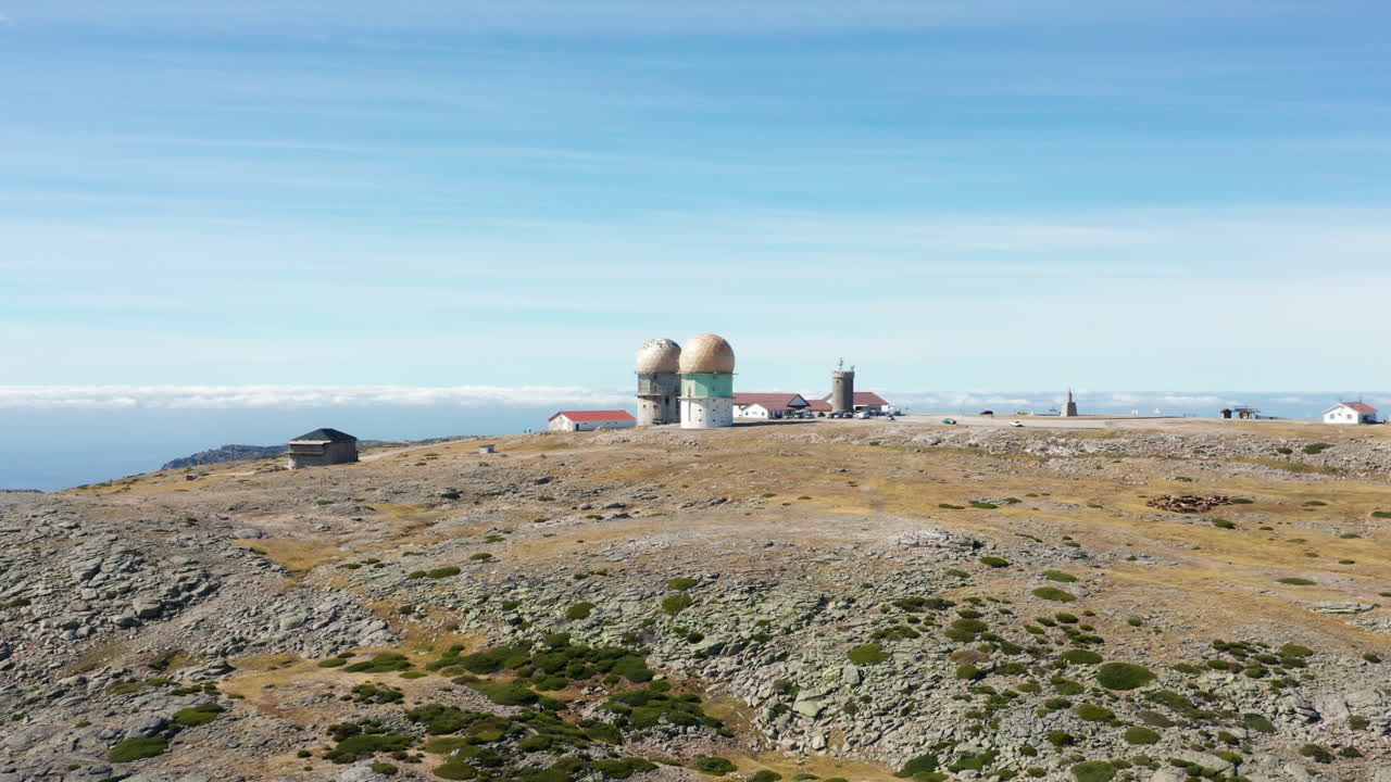 Aerial ascending shot over Serra da Estrela top observatory station, Portugal