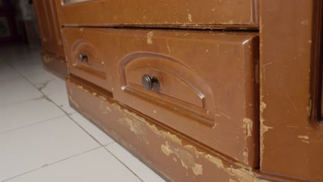 person closing an old fashioned wooden closet drawer